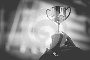 Black and white trophy with city background. Success and achievement concept. Sport game and award theme. Monochrome color theme