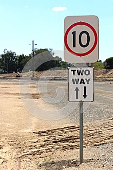Black and white Two Way sign with arrows and speed limit