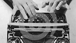 Black and white typing on a vintage typewriter machine. Writing a love letter by the window,