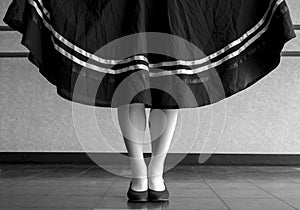 Black and white version of character ballet parallel position with skirt held