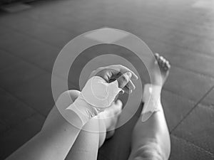 Black and white version of The injured athlete- athlete with thumb and ankle injuries and tape jobs