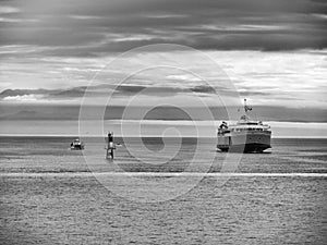 Black and white version of Passenger and Car Ferry In the Ocean Bay