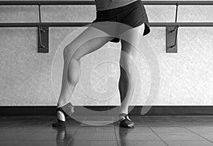 Black and White version of Posing in Jazz shoes at the barre in dance class