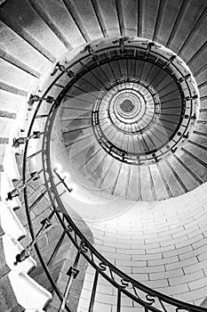 Black and white vertical real photography of Spiral stairs inside the lighthouse