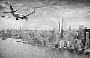 Black and white view of airplane over New York City. Tourism con