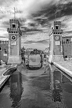 Black and white view of The Arsenal of Venice, Veneto, Italy, against a dramatic sky