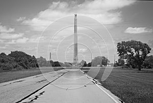 A black and white view down the entrance road leading to the San Jacinto Monument.