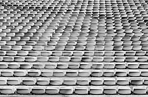 Black and white view of endless rows of empty chairs in a stadium