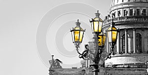 Black and white view of Saint Isaac Cathedral in St. Petersburg with color vintage street lamp with yellow light