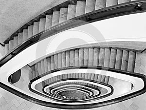 Black and white View to the beautiful spiral staircase in building , Spiral circle staircase decoration interior background