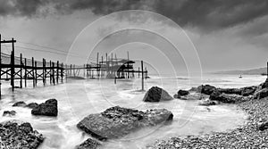 black-and-white view of the Trabocco Cungarelle pile dwelling on an overcast an rainy day on the Costa dei Trabocchi in Italy