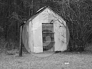 Black and white vintage back yard small wooden barn