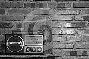 A black white vintage retro radio receiver in fornt of brick wall