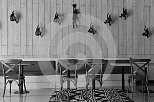 black and white walls with wall ornaments and chairs