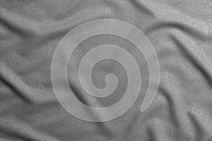 Black and white wavy silk fabric with folds. Mockup and blank designer for making a flag on a gray background