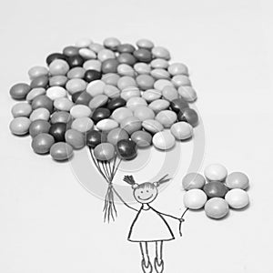 Black and white. weightlessness. Girl with balls of sweets. Rise