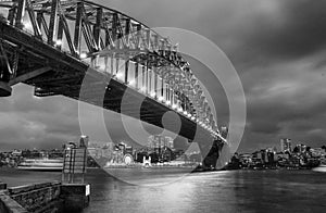 Black and white wide angle view of Sydney Harbour Bridge at nigh