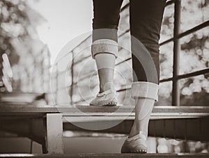 Black and white woman is stepping up a staircase