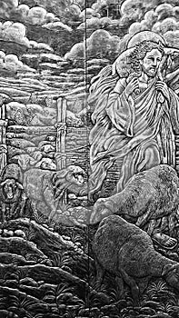 Black and White Wood Carving portraying of Jesus carrying sheep