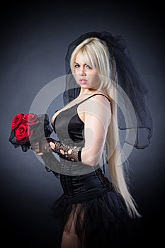 Black widow in grief with flowers with a veil