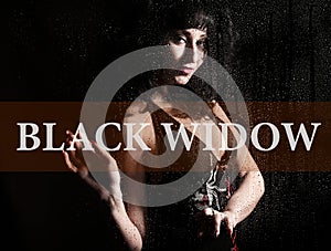Black widow written on virtual screen. hand of young woman melancholy and sad at the window in the rain.