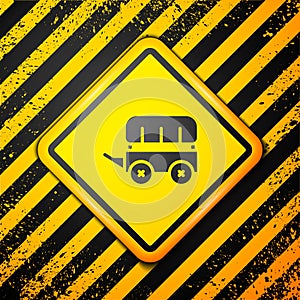 Black Wild west covered wagon icon isolated on yellow background. Warning sign. Vector