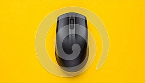 Black Wireless Computer Mouse Centered on a Vibrant Yellow Background wireless mouse black mouse