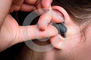 Black wireless headphones in ear