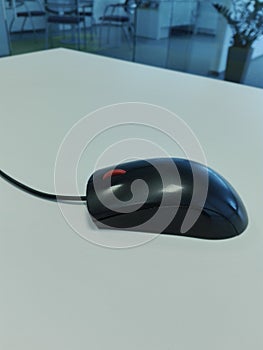 Black wireless mouse, office table