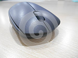 Black wireless mouse over a desk