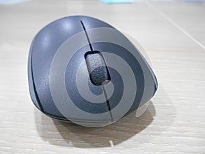 Black wireless mouse over a desk