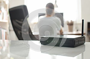 Black wireless router on white reflective surface