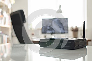 Black wireless router on white reflective table