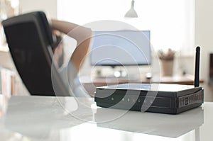 Black wireless router on white reflective table