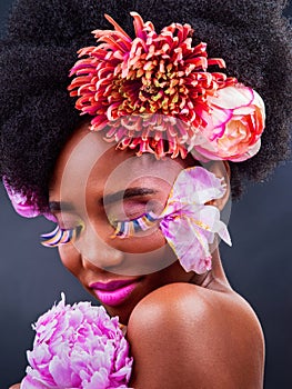 Black woman, afro or flowers of organic, beauty or hair care of spring, health or wellness in studio. African girl, rose