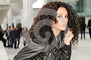 Black woman, afro hairstyle, in urban background