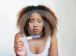 Black woman, anxiety and fear in house with pregnancy test for baby, infertility and future family. Girl, stress and