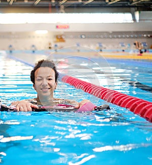 Black woman attending water aerobics class in a swimming pool