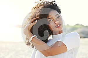 Black woman, beauty and portrait at beach for vacation, freedom and face with natural hair and smile. Happy young female