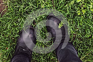 Black woman boots on green grass