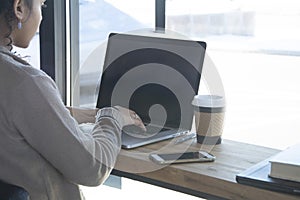 Black woman business owner types on computer for work