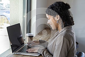 Black woman business owner types on her computer while working