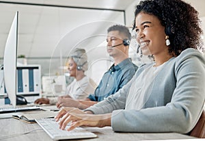 Black woman, call center consultant and contact us with CRM and happy employee at desk with keyboard and computer