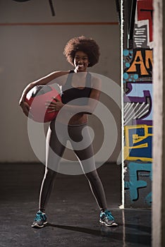 Black woman carrying crossfit ball