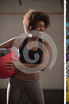 Black woman carrying crossfit ball