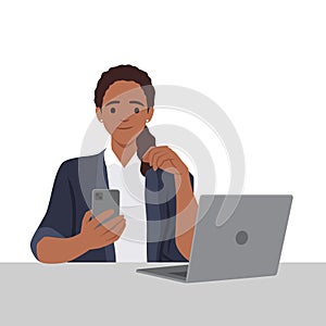 Black Woman chatting on a smartphone sitting at the desk. Happy freelancer or office female working remotely use a laptop