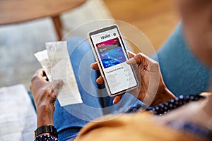 Black woman checking digital wallet on smartphone