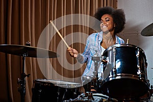 Black woman drummer in a recording studio