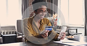 Black woman ebank customer enjoy paying from card using smartphone