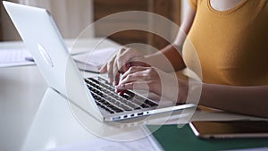 Black woman entrepreneur sit at desk typing on laptop closeup Spbd. female freelancer working